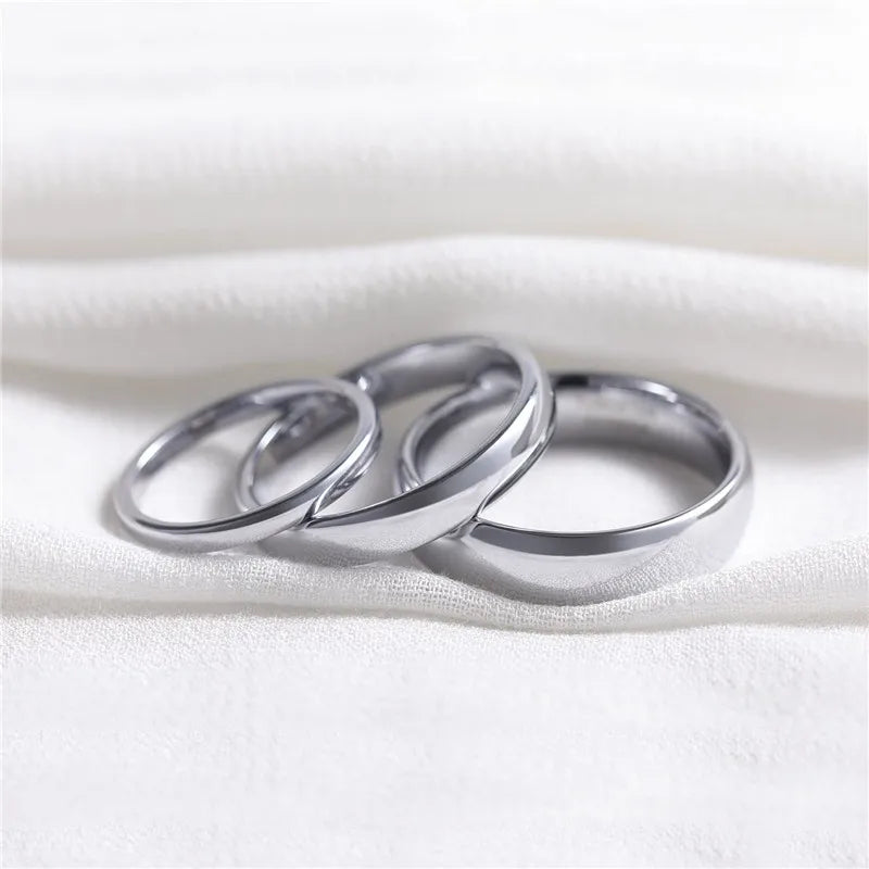 a couple of rings sitting on top of a white blanket