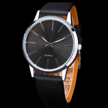 a black and silver watch on a black background