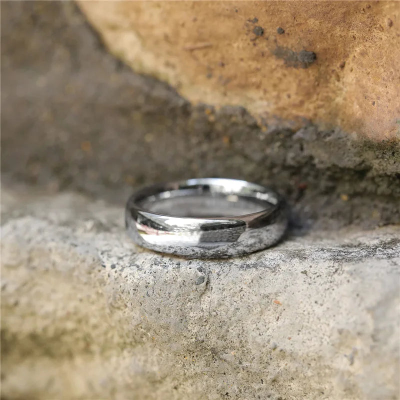 a close up of a wedding ring on a rock