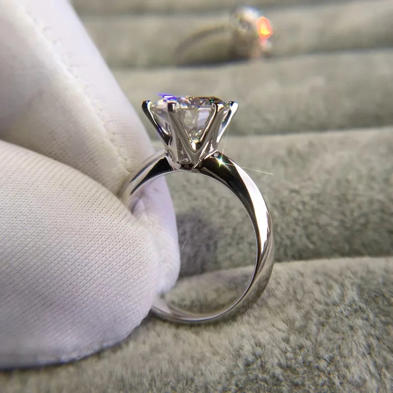 a diamond ring sitting on top of a white cloth