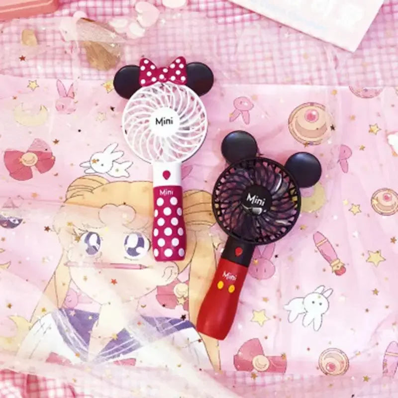 a minnie mouse fan and a minnie mouse hair brush