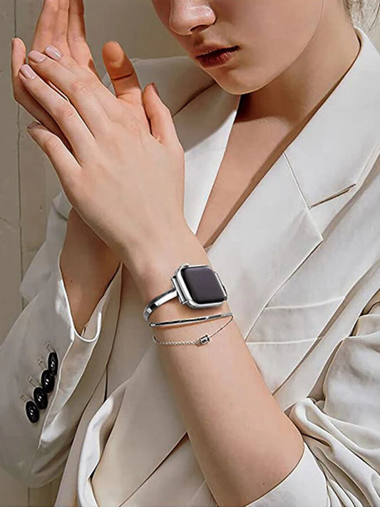 a woman wearing a watch and a white shirt