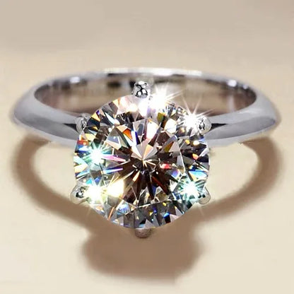 a close up of a diamond ring on a table