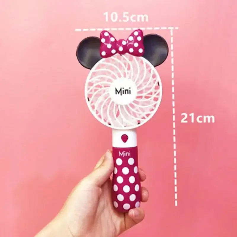 a person holding a minnie mouse fan in their hand